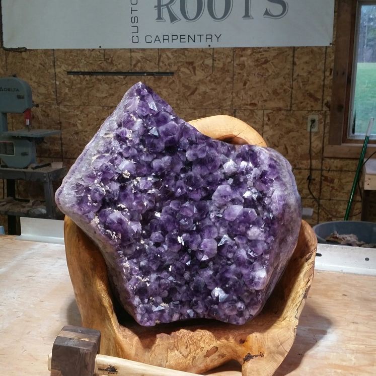 Amethyst geode on a maple burl display stand
