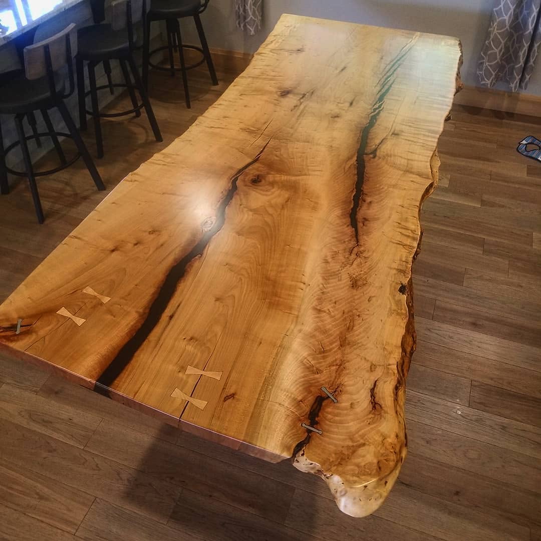 Live-edge walnut dining table on blackened-steel base
